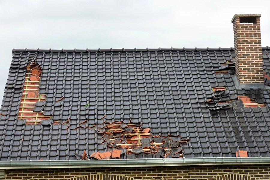 A damaged roof with missing shingles in Springfield, IL.